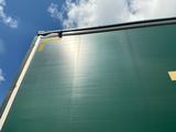 a large green sign on the side of a building