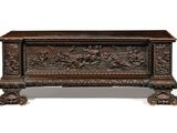 an old wooden trunk with carvings and carvings on the sides