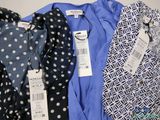 several different types of clothing are on display on a table