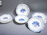 un ensemble d'assiettes et de bols bleus et blancs posés sur une table