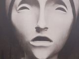 black and white photograph of a sculpture of a woman ' s face