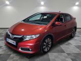 a red honda civic is parked on a checkered floor