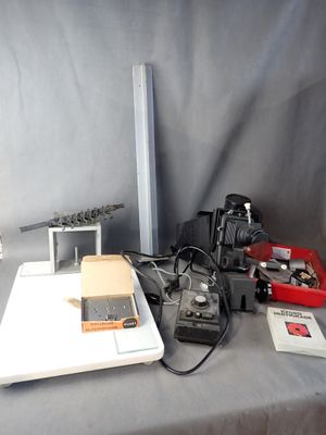 a laptop computer sitting on top of a table next to a camera