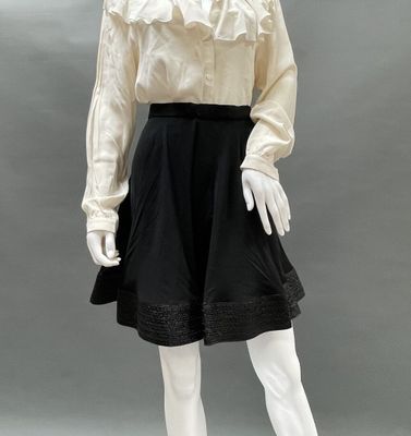 an image of a mannequin wearing a white blouse and black skirt