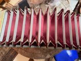 a red and white accordion sitting on top of a table