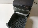 a black and gray food processor sitting on a counter