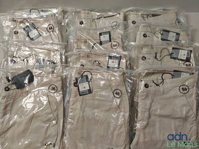 several pairs of pants are wrapped in plastic bags on a table