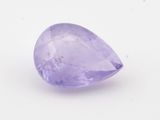 gros plan d'une pierre précieuse violette sur une surface blanche