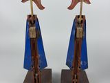 pair of wooden sculptures of a man and a woman with wings