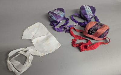a pair of shoes, a bag, and a pair of headbands on a table