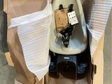 a baby seat in a cardboard box with a camera attached to it
