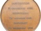 an old bronze medal with the date of the convention on it