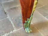 a close up of a wooden bench on a brick floor