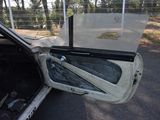 an open door of a car that is parked in a lot