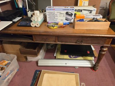 a desk with a laptop and other office supplies on it