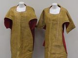 pair of mannequins in yellow and red dress on display