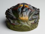an image of a ceramic sculpture of a bird on a leaf
