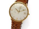 a close up of a wrist watch on a white surface