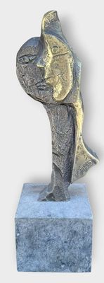 a statue of a fish that is sitting on top of a block