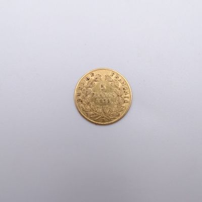 a close up of a gold coin on a white surface