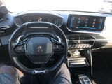 someone is sitting in the driver ' s seat of a car with their feet on the steering wheel