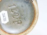 a close up of a vase with a tag on it