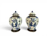 pair of chinese blue and white vases with lids on stands