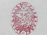 a close up of a red and white logo on a white towel
