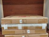 a stack of boxes sitting on top of a wooden shelf