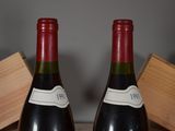 two bottles of wine sitting next to each other on a table