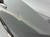someone is peeling the paint off of a car ' s door handle