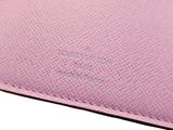 a close up of a pink wallet on a white background