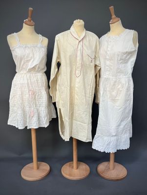 three dresses on mannequins on display against a gray background