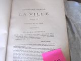 a book with a pink sticker on it sitting on a bed