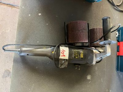 a machine that is sitting on the floor next to some tools