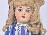 a doll that is wearing a blue dress and a hat