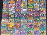 a pile of pokemon cards sitting on top of a table