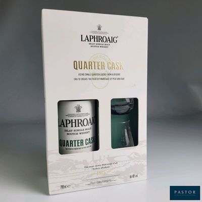 the packaging of a bottle of laphrong quartered gin next to a glass of water