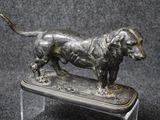 a statue of a dog that is standing on a table