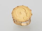 a gold coin ring with a profile of a man