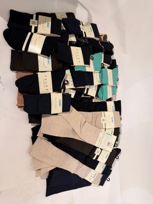 several pairs of men ' s socks are stacked on top of each other