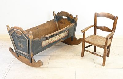 a wooden rocking chair and a rocking cradle in a room