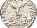a silver coin with an image of a man and a dog on it