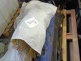 a bag of hay sitting on top of a pile of pallets