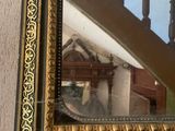 a mirror hanging on the wall next to a staircase