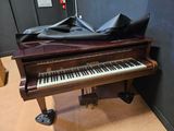 a piano that is sitting on the floor in a room