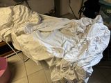 a bed that is covered with a sheet in a room