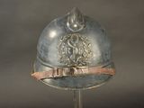 a silver helmet with a metal band around the neck
