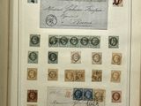 an open book with stamps on it sitting on a table
