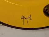 a yellow plate with writing on it sitting on a table